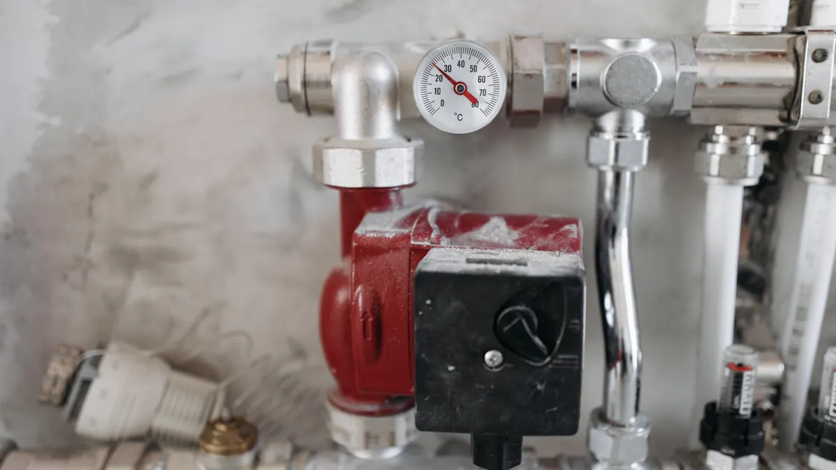 Plumbing assembly with a pressure gauge and pump